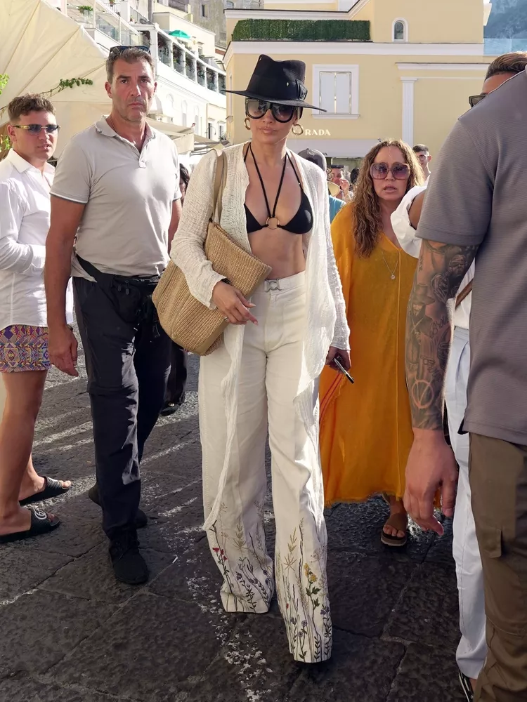 Jennifer Lopez Flaunts Black String Bikini as a Top While Capri Shopping Spree.